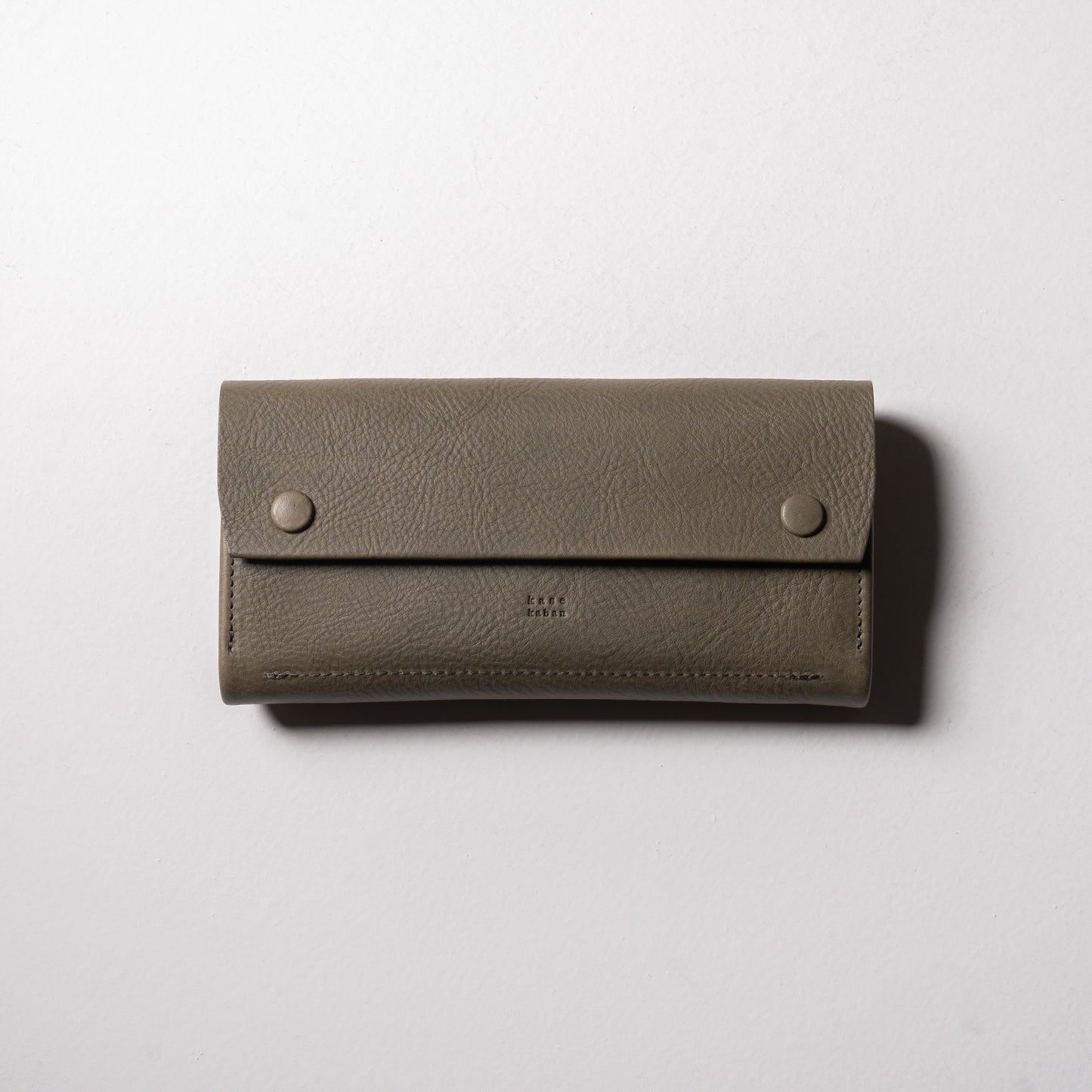 【金具を隠した一枚革】ふっくらと包み込む、くるみホックの長財布。イタリア革 ＜グリージオ＞