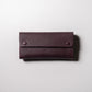 【金具を隠した一枚革】ふっくらと包み込む、くるみホックの長財布。イタリア革 ＜パープル＞
